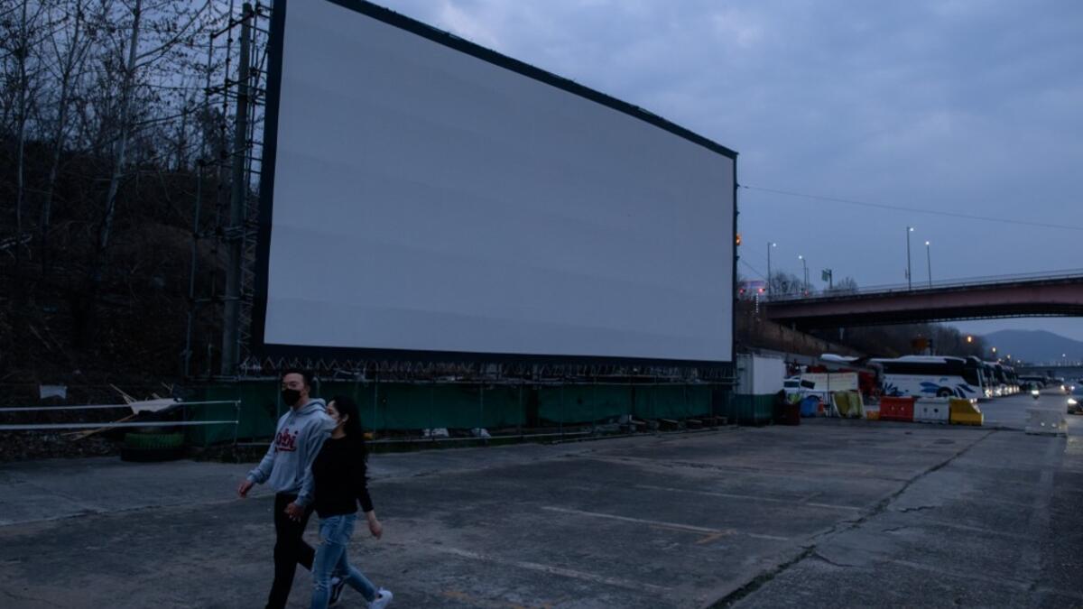 But at drive-in cinemas, moviegoers can enjoy a movie from the comfort of their cars, parked in front of a large outdoor screen.  Ed JONES / AFP