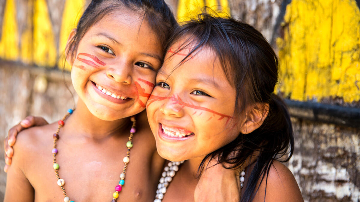 Cute Brazilian indians paying in Amazon, Brazil (Shutterstock)