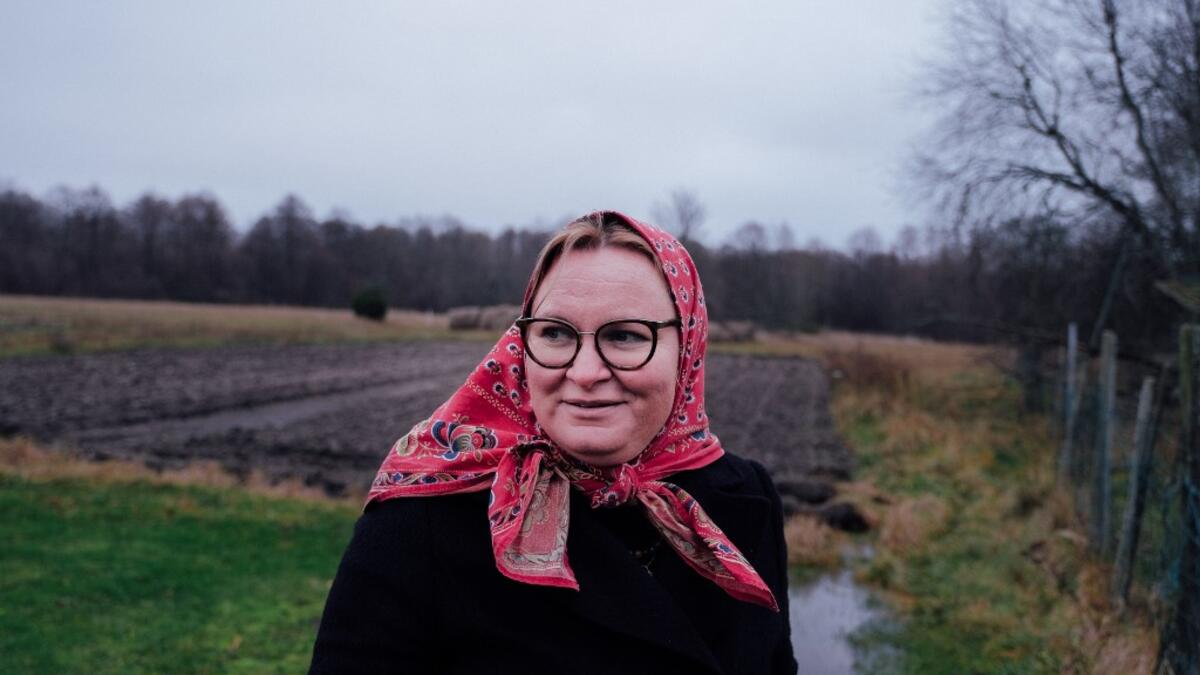 Mare Mätas, local tour guide, answers journalists' questions on November 20, 2019 on Kihnu island in the Baltic Sea, 10 kilometres (six miles) off the coast of Estonia. Steeped in folk traditions, Kihnu's historic way of life however is now threatened as economic hardship drives more and more islanders away in search of work. Alessandro RAMPAZZO / AFP