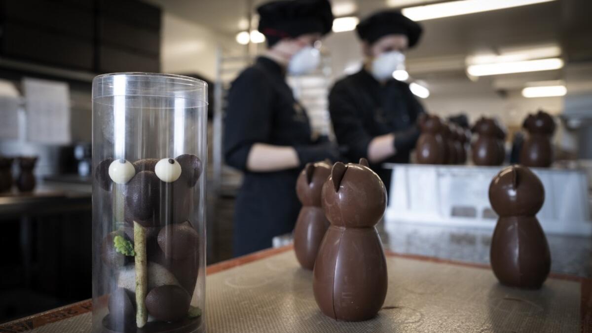 Employees work in the laboratory of the of the Criollo chocolate factory as they prepare chocolate for the Easter week, on April 06, 2020 in Saint-Pierre-De-Lages near Toulouse southern France, on the twenty-first day of a strict lockdown in France to stop the spread of COVID-19, caused by the novel coronavirus. Lionel BONAVENTURE / AFP