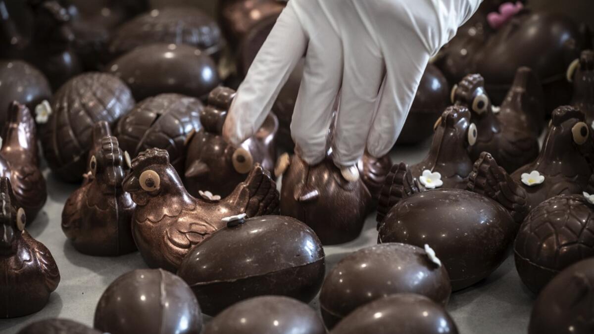 An employee of pastry and chocolate maker Didier Girard prepares Easter chocolate before delivering them at clients' homes in Vourles, near Lyon at on April 7, 2020, on the twenty-second day of a strict lockdown in France to stop the spread of COVID-19, caused by the novel coronavirus. JEAN-PHILIPPE KSIAZEK / AFP