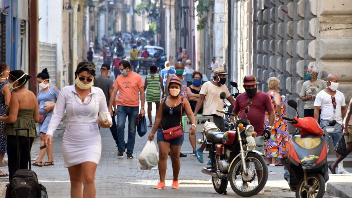 People get to the street to buy food in Havana, on April 12, 2020 amid the spread of the COVID-19 disease. ADALBERTO ROQUE / AFP