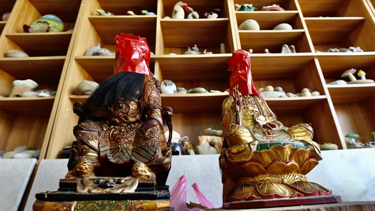This picture taken on March 17, 2020 shows Taoist god statues after they were discarded by people not using them anymore, at the workplace of sculptor Lin Hsin-lai in Taoyuan, northern Taiwan. Every spare surface of Lin Hsin-lai's four-storey shop is crammed with a pantheon of Taiwan's celestial beings, testament to the decades he has spent sheltering and restoring unwanted statues of gods.  Sam Yeh / AFP