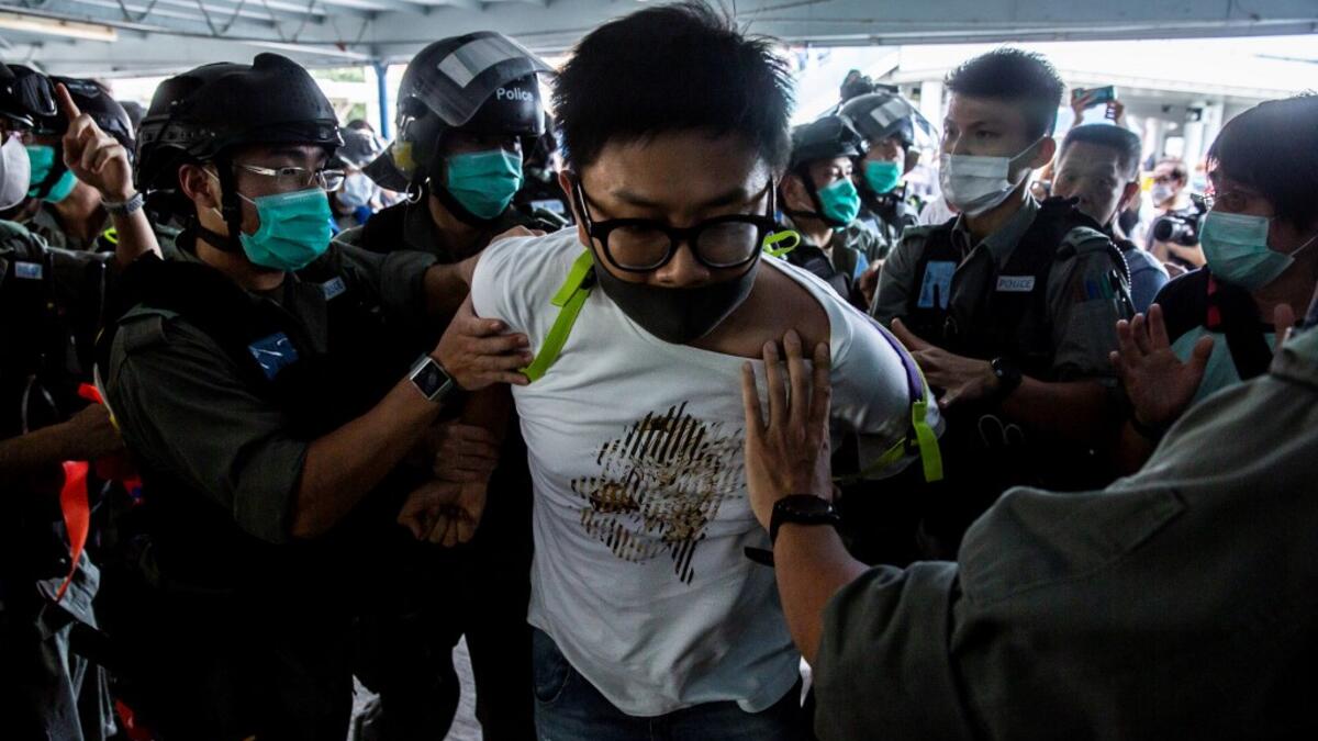 Police officers arrest a pro-democracy demonstrator (C) during a pro-democracy protest calling for the city's independence in Hong Kong on May 10, 2020. ISAAC LAWRENCE / AFP