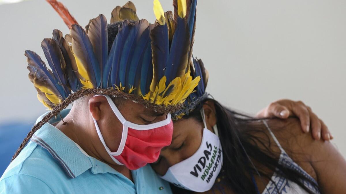 Indigenous from the Parque das Tribos community mourns at the funeral of Chief Messias, 53, of the Kokama tribe who died victim of the new coronavirus, COVID-19, in Manaus, Brazil, on May 14, 2020. MICHAEL DANTAS / AFP