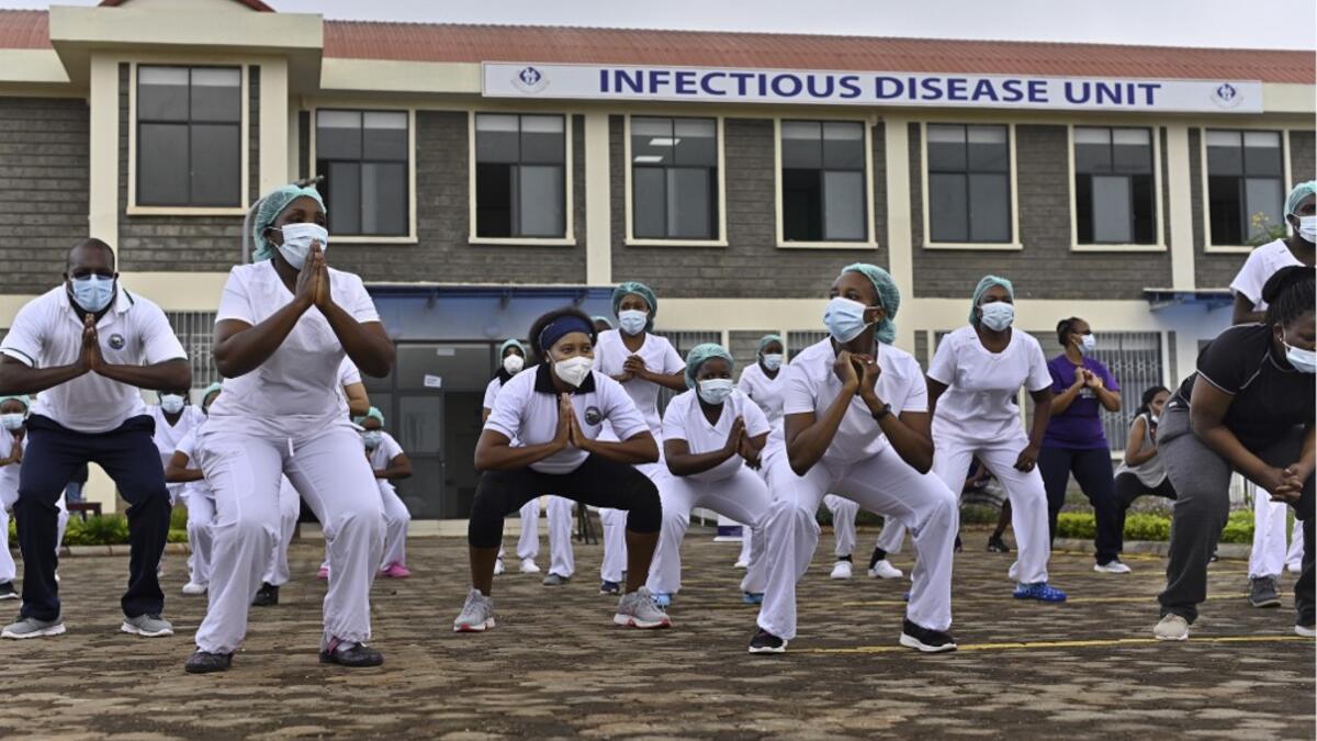 Nurses assigned to the Infectious Diseases Unit (IDU) at the Kenyatta University Hospital dance during a Zumba class held at the hospital compound in Nairobi, on May 17, 2020. Coinciding with the morning shift rotation the class, aimed to offer some respite to nurses charged with the management of patients infected with COVID-19 coronavirus, was organised by the Nursing Council of Kenya (NCK) and the Kenyatta Univesity Teaching, Refferal and Research Hospital in the Kenyan capital. TONY KARUMBA / AFP