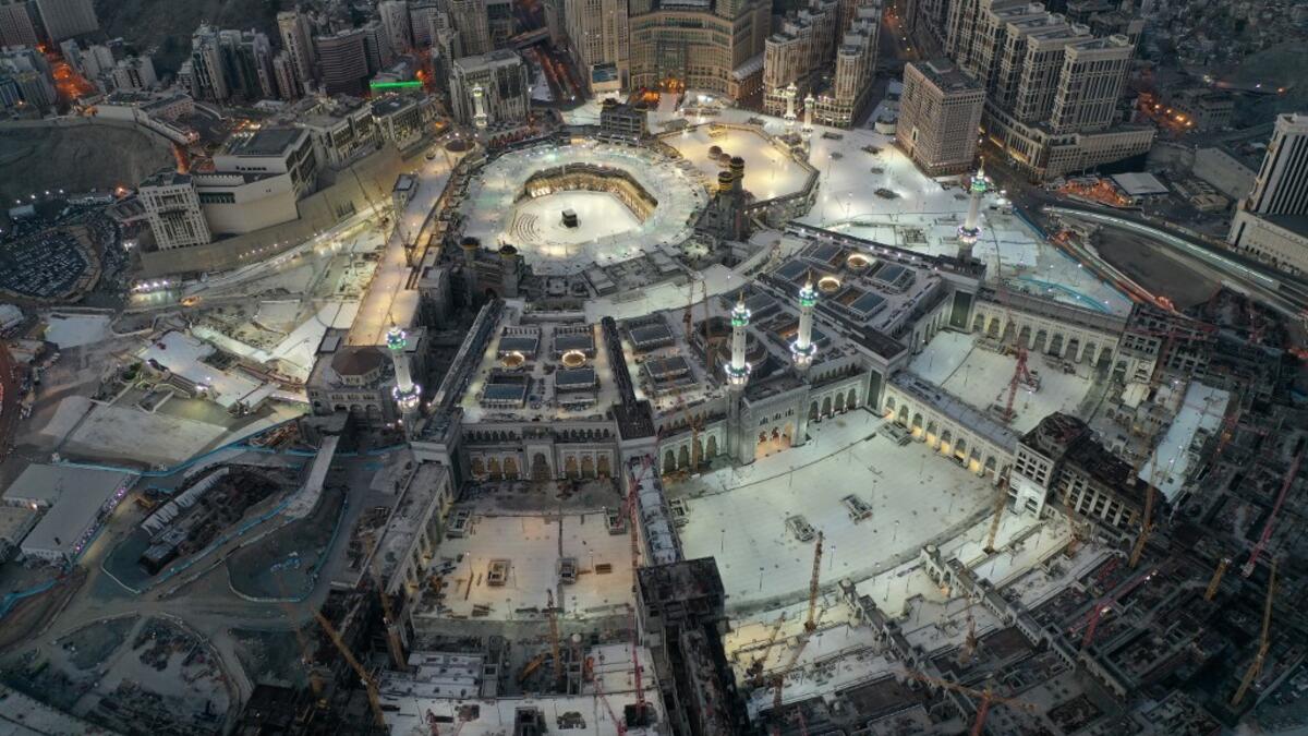This picture taken on May 24, 2020 during the early hours of Eid al-Fitr, the Muslim holiday which starts at the conclusion of the holy fasting month of Ramadan, shows an aerial view of the Grand Mosque and Kaaba in the centre of Saudi Arabia's holy city of Mecca. Saudi Arabia began a five-day, round-the-clock curfew from May 23 after COVID-19 coronavirus infections more than quadrupled since the start of Ramadan to around 68,000 -- the highest in the Gulf. STR / AFP