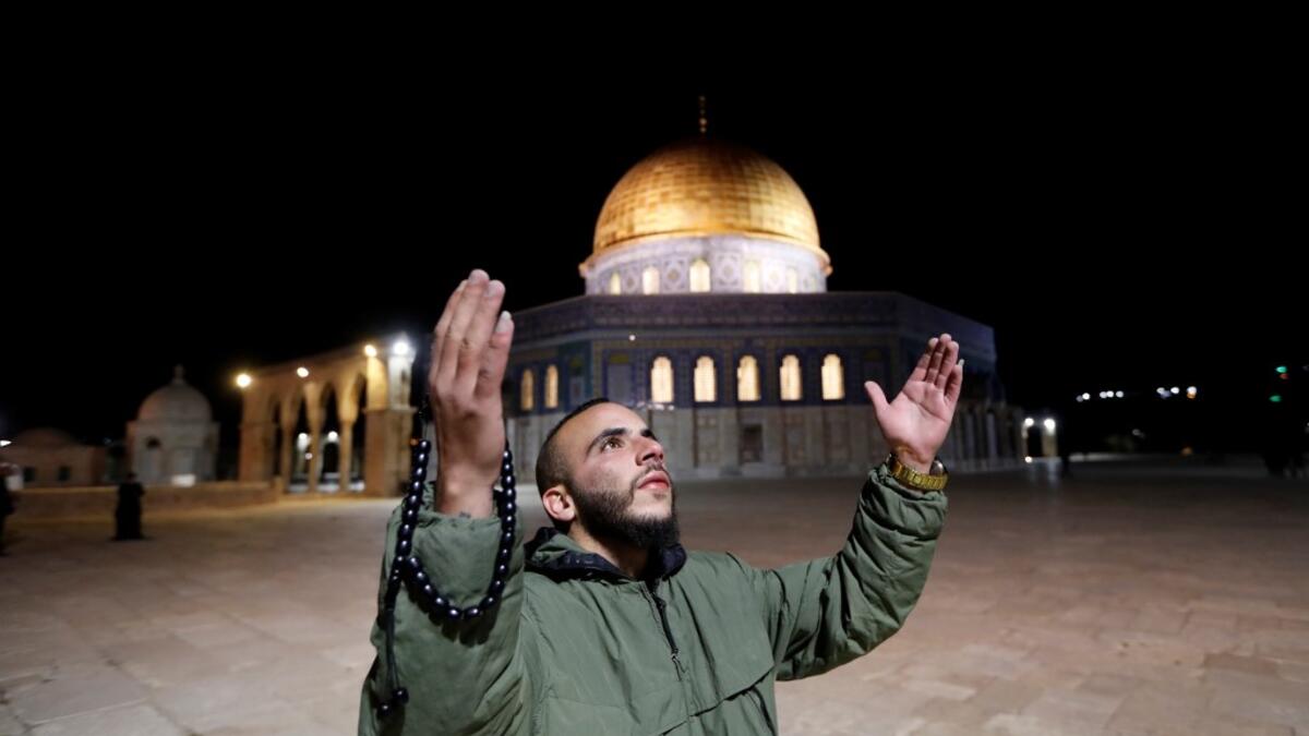 A Palestinian man prays in front of the Dome of the Rock at the al-Aqsa mosque compound, in Jerusalem's Old City on May 31, 2020, after a two-month closure due to the COVID-19 pandemic. Ahmad GHARABLI / AFP