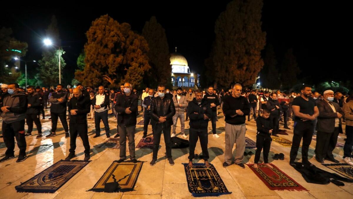 Palestinians perform the dawn prayer (salat al-fajr) inside the al-Aqsa mosque compound, in Jerusalem's Old City on May 31, 2020, after a two-month closure due to the COVID-19 pandemic. AHMAD GHARABLI / AFP