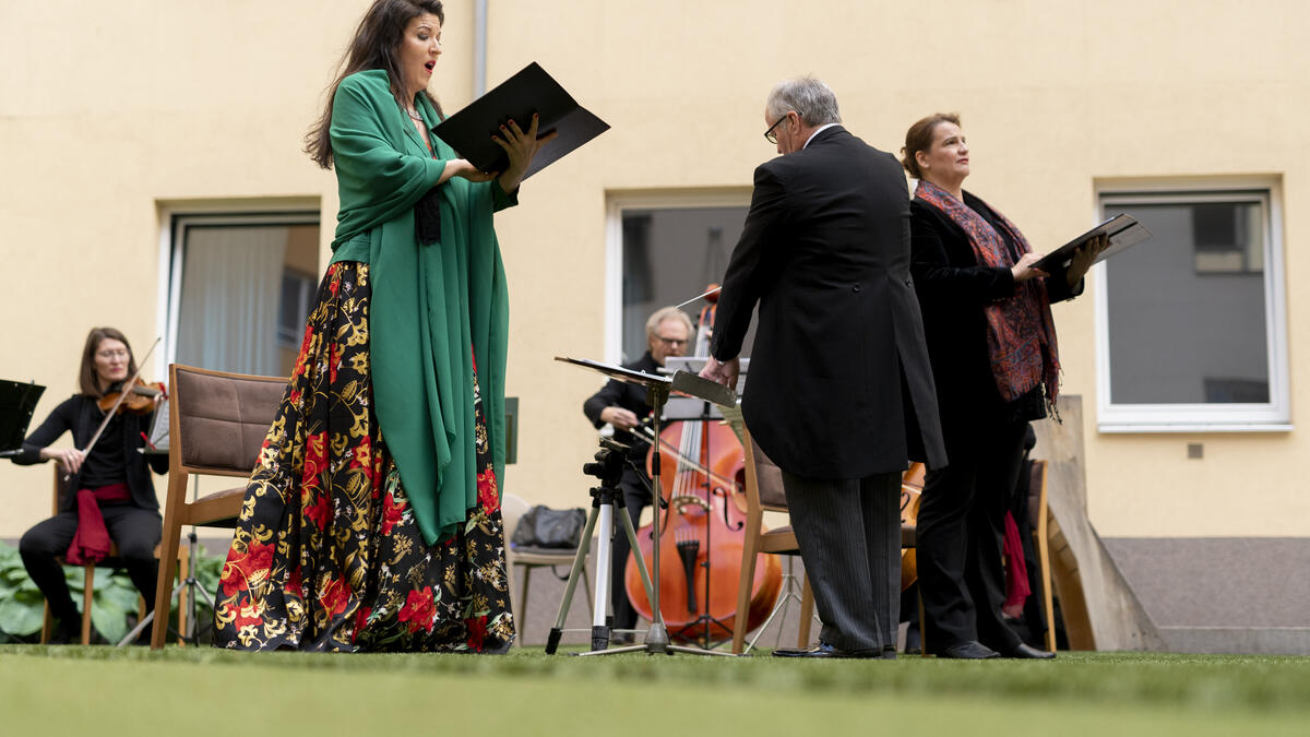 Monika Medek (L) and Dagmar Dekanovsky (R) and the Camerata Carnutum orchestra, perform for guests of Zeitgeist Hotel during a window concert (Fensterkonzert) in Vienna on May 30, 2020, as hotels and cultural events have reopened in Austria amid the novel coronavirus pandemic. JOE KLAMAR / AFP