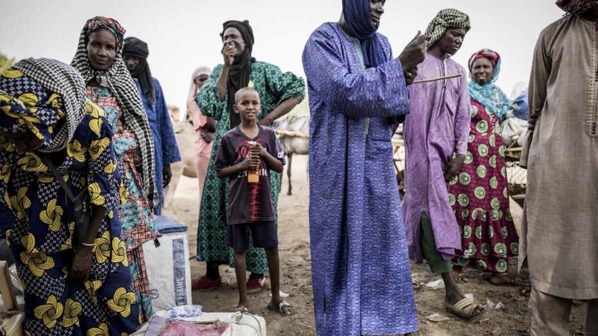 Fulani herders buy and sell goods at a unofficial herders market in Barkedji on May 28, 2020. COVID-19 coronavirus restrictions have closed down markets and regional movement, as a result Fulani herders are struggling to move to areas with more grazing land for there live stock. Closures of markets have meant that the prices for live stock has dropped by up to fifty percent, leaving the pastoralist stuck with out being able to pay for the provisions to move on. JOHN WESSELS / AFP