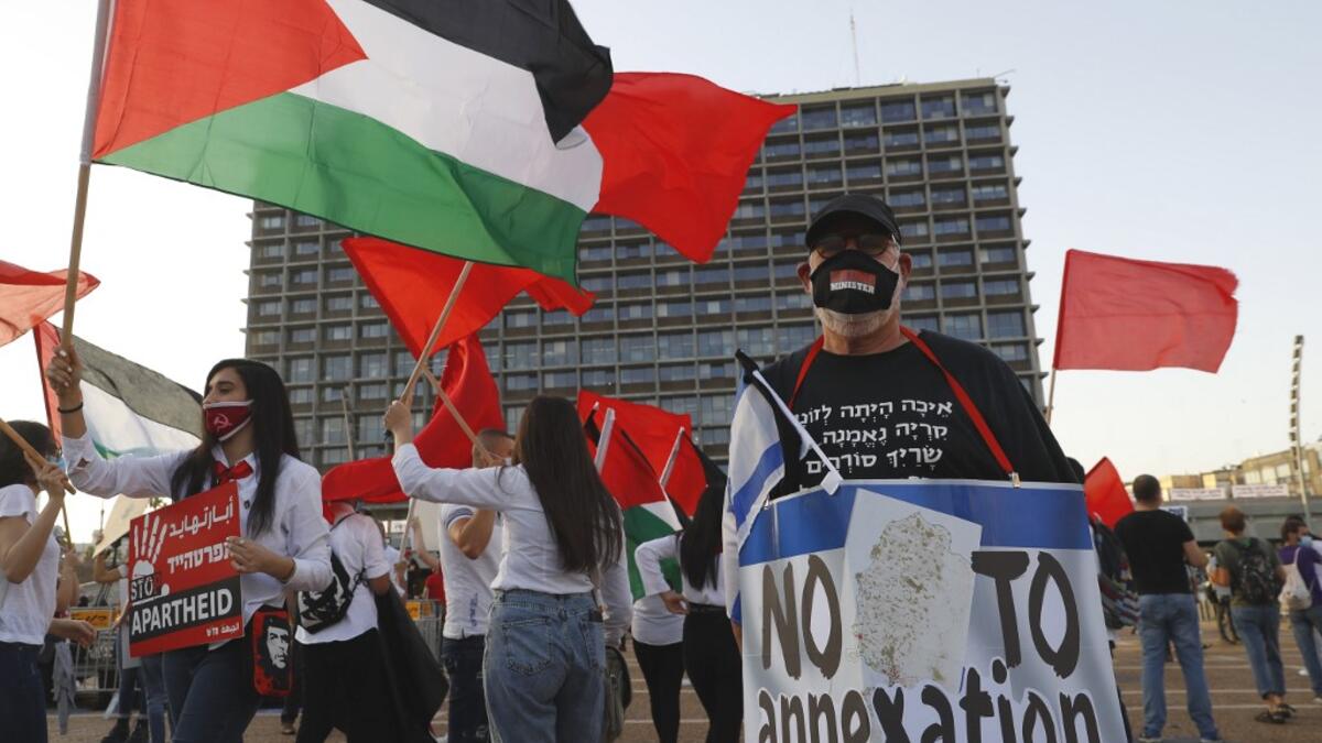 Protesters gather in Tel Aviv's Rabin Square on June 6, 2020, to denounce Israel's plan to annex parts of the occupied West Bank. Israeli Prime Minister Benjamin Netanyahu has vowed to forge ahead with annexing settlements and the Jordan Valley, in line with the peace proposals unveiled in January by US President Donald Trump. The plan has been angrily rejected by the Palestinians, who say they were not consulted on proposals they see as capitulating to Israeli demands. JACK GUEZ / AFP