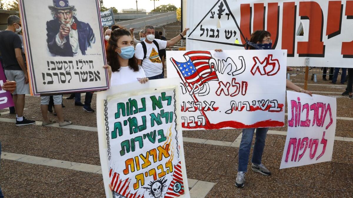 Protesters gather in Tel Aviv's Rabin Square on June 6, 2020, to denounce Israel's plan to annex parts of the occupied West Bank. Israeli Prime Minister Benjamin Netanyahu has vowed to forge ahead with annexing settlements and the Jordan Valley, in line with the peace proposals unveiled in January by US President Donald Trump. JACK GUEZ / AFP