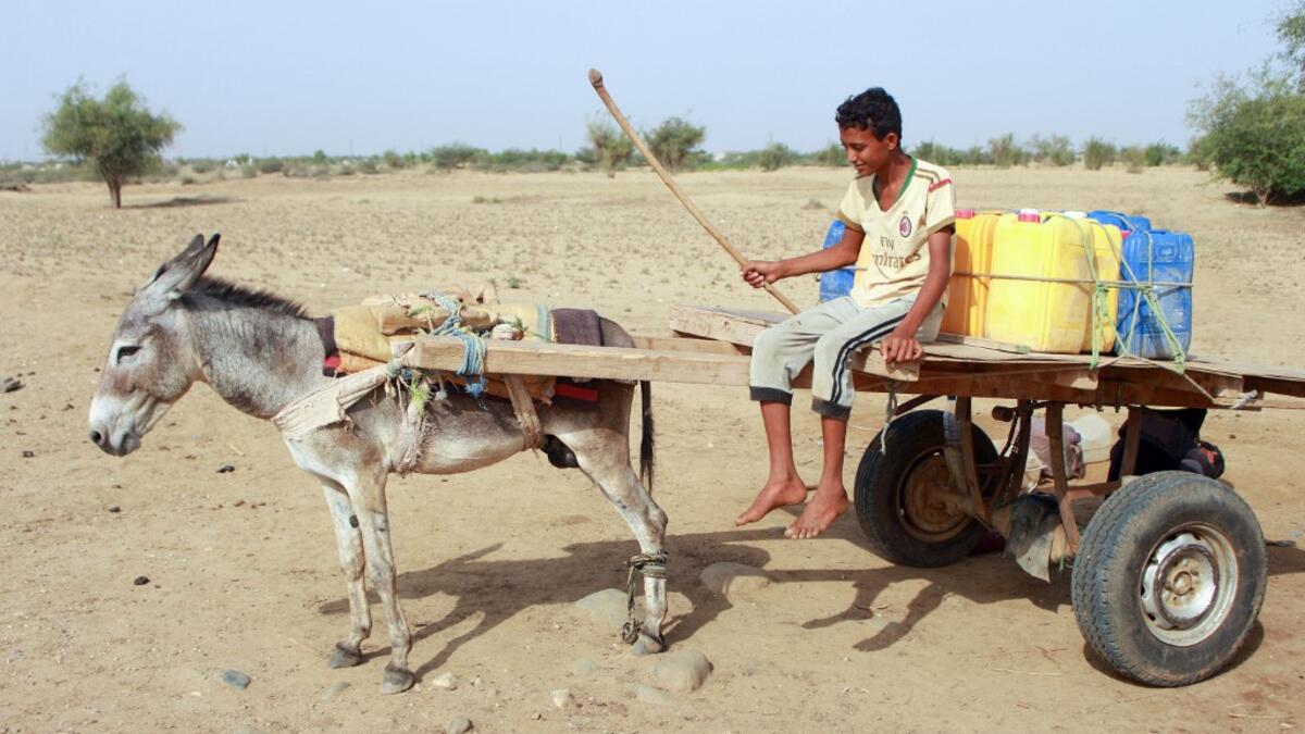 A Yemeni youth riding a donkey cart arrives to fill jerrycans with water from a cistern at a make-shift camp for the internally displaced, in the northern Hajjah province, on June 7, 2020, amid a severe shortage of water. ESSA AHMED / AFP