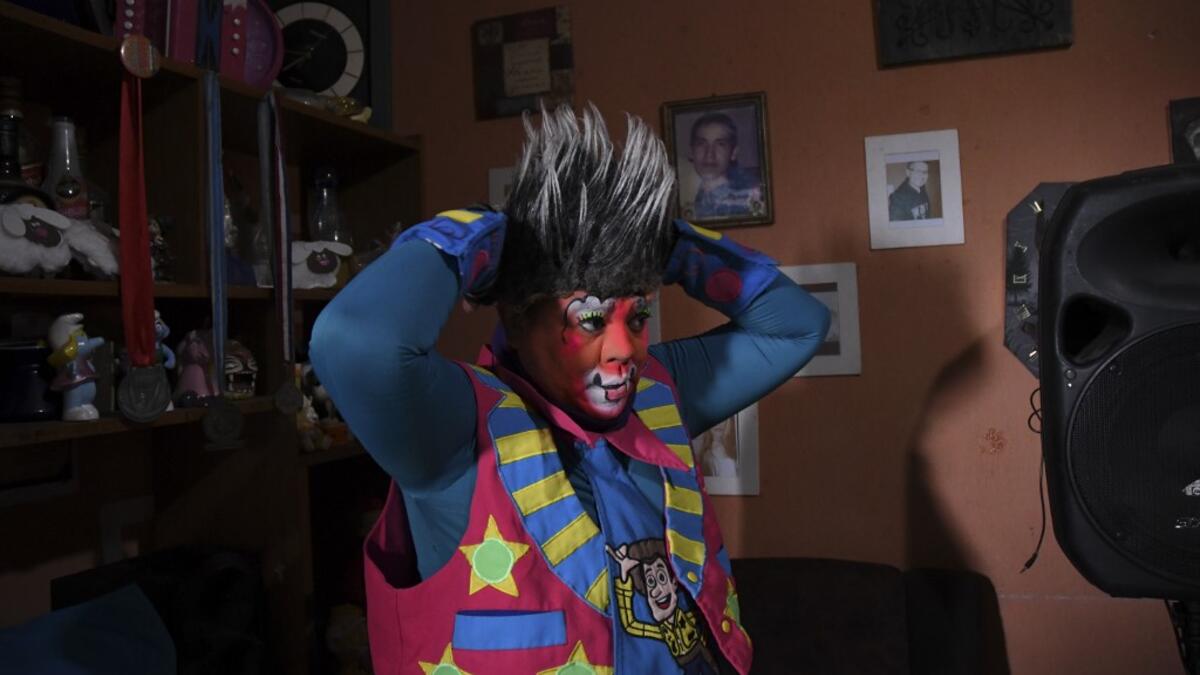 Mostacita.com clown prepares before taking to the streets to beg for money to survive the crisis caused by the new coronavirus in Villa Nueva, 20 km south Guatemala City, on June 10, 2020, as clowns have been unable to work due to restrictions to prevent the spread of the COVID-19.  Johan ORDONEZ / AFP
