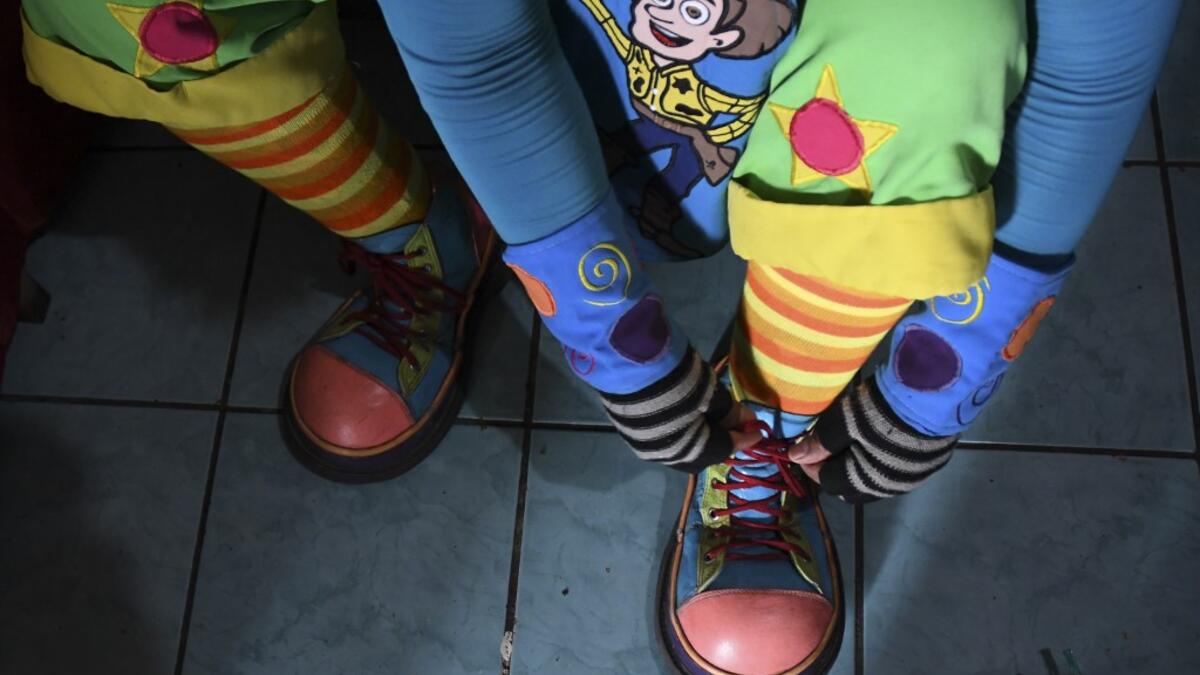 Mostacita.com clown prepares before taking to the streets to beg for money to survive the crisis caused by the new coronavirus in Villa Nueva, 20 km south Guatemala City, on June 10, 2020, as clowns have been unable to work due to restrictions to prevent the spread of the COVID-19. Johan ORDONEZ / AFP