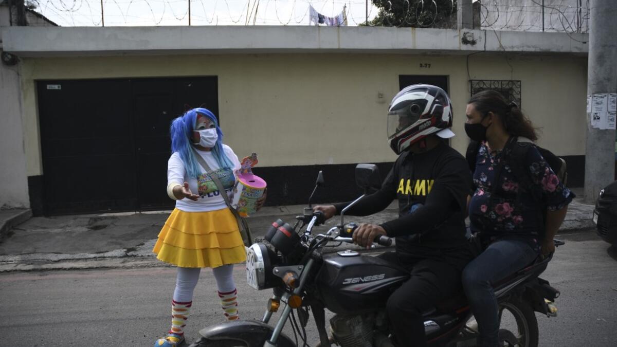 A clown begs for money to survive the crisis caused by the new coronavirus in Villa Nueva, 20 km south Guatemala City, on June 10, 2020, as clowns have been unable to work due to restrictions to prevent the spread of the COVID-19.    Johan ORDONEZ / AFP