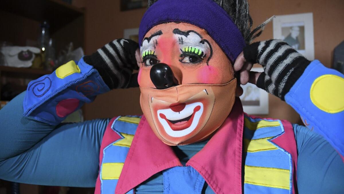 Mostacita.com clown prepares before taking to the streets to beg for money to survive the crisis caused by the new coronavirus in Villa Nueva, 20 km south Guatemala City, on June 10, 2020, as clowns have been unable to work due to restrictions to prevent the spread of the COVID-19. Johan ORDONEZ / AFP