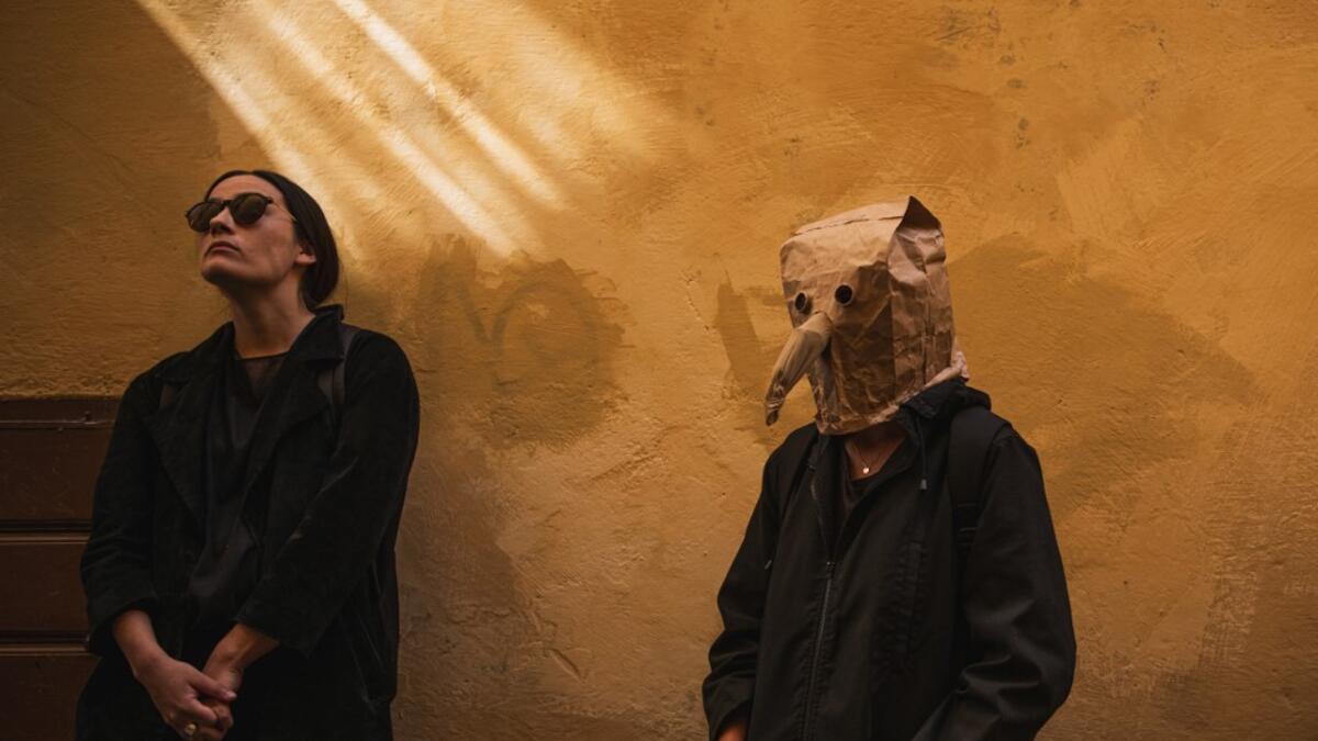 Visitors are pictured on May 30 ,2020 during a 'plague walk' tour by guide Mike Anderson , taking them around sites in Stockholm's old town related to pandemics of the plague in the 14th and 18th century, and an outbreak of cholera that hit the city in the mid-19th century. Jonathan NACKSTRAND / AFP