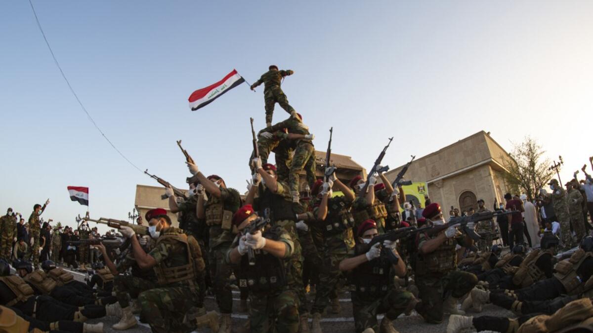Members of the Hashed al-Shaabi (Popular Mobilisation) paramilitary force take part in a military parade in the southern Iraqi city of Basra on June 14, 2020, marking the sixth anniversary of its founding after Iraq's top Shiite cleric Grand Ayatollah Ali Sistani called to defend the country from the Islamic State group (IS). Hussein FALEH / AFP