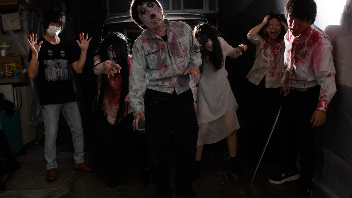 This picture taken on June 15, 2020 shows a group photo of (L-R) sound and lights engineer Daichi Ono, 33, Ayaka Imaide, 34, Kenta Iwana, 25, Haruna Suzuki, 20, Asami Takeuchi, 33, Kota Hanegawa, 28, posing before an interview in a drive-in haunted house in Tokyo. Philip FONG / AFP