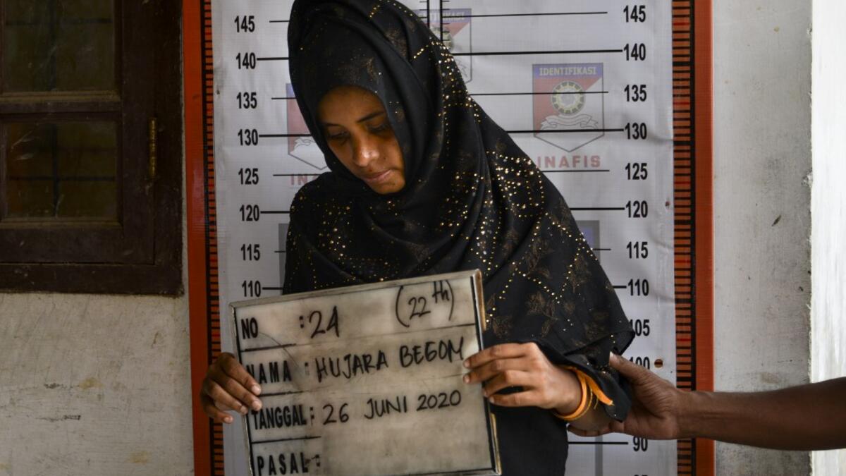 A Rohingya woman from Myanmar goes through an identification procedure by Indonesian police at the immigration detention centre in Lhokseumawe in Indonesia's North Aceh Regency on June 26, 2020. Nearly 100 Rohingya asylum seekers stranded off the coast of Indonesia were pulled to shore on June 25 by locals angered at the refusal of authorities to give them shelter over coronavirus fears. CHAIDEER MAHYUDDIN / AFP