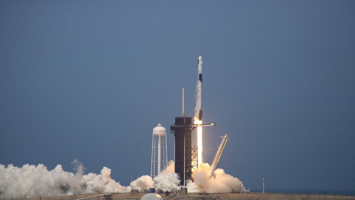 The SpaceX Falcon 9 rocket launches into space with NASA astronauts Bob Behnken (R) and Doug Hurley aboard the rocket from the Kennedy Space Center on May 30, 2020 in Cape Canaveral, Florida. The inaugural flight is the first manned mission since the end of the Space Shuttle program in 2011 to be launched into space from the United States. Saul Martinez/Getty Images/AFP