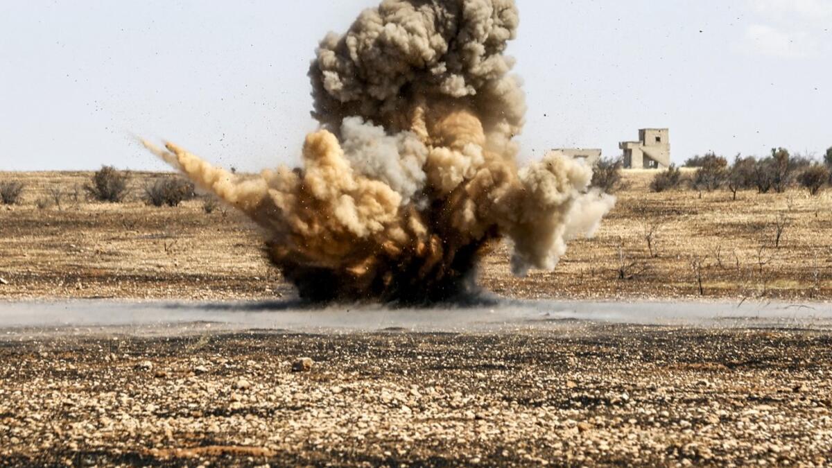 A landmine is remotely detonated in a field at a pistachio orchard in the village of Maan, north of Hama in west-central Syria on June 24, 2020. Pistachio farmers in central Syria are hoping that reduced violence will help revive cultivation of what was once one of the country's top exports. LOUAI BESHARA / AFP