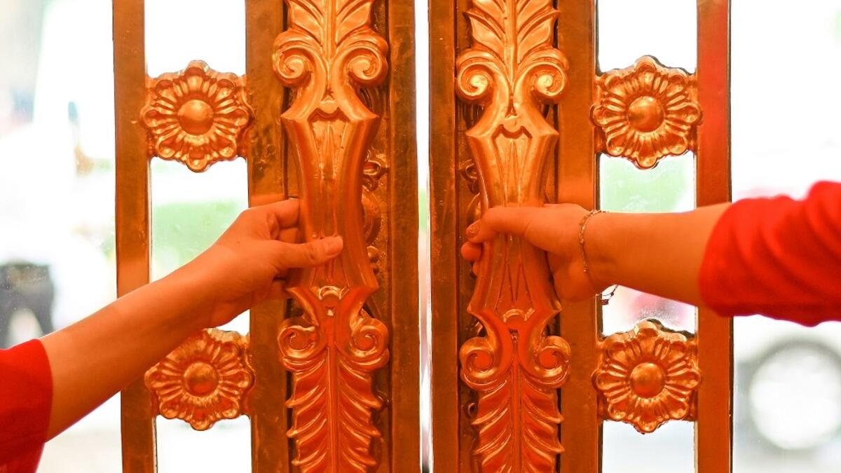 Hotel staff wait to welcome guests in the lobby of the newly-inaugurated Dolce Hanoi Golden Lake hotel, the world's first gold-plated hotel, in Hanoi on July 2, 2020. Manan VATSYAYANA / AFP