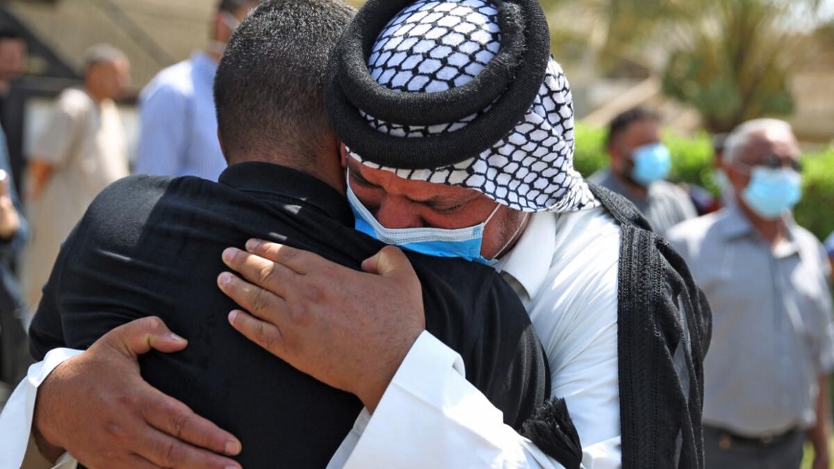 Mourners embrace during the funeral of slain Iraqi jihadism expert Hisham al-Hashemi, who was shot dead yesterday outside his house in the Iraqi capital, in Baghdad’s Zayouna district on July 7, 2020. Hashemi was an authoritative voice on Sunni jihadist factions including the Islamic State group, but was also frequently consulted by media and foreign governments on domestic Iraqi politics and Shiite armed groups. He had warm ties with top decision-makers, including President Barham Saleh.