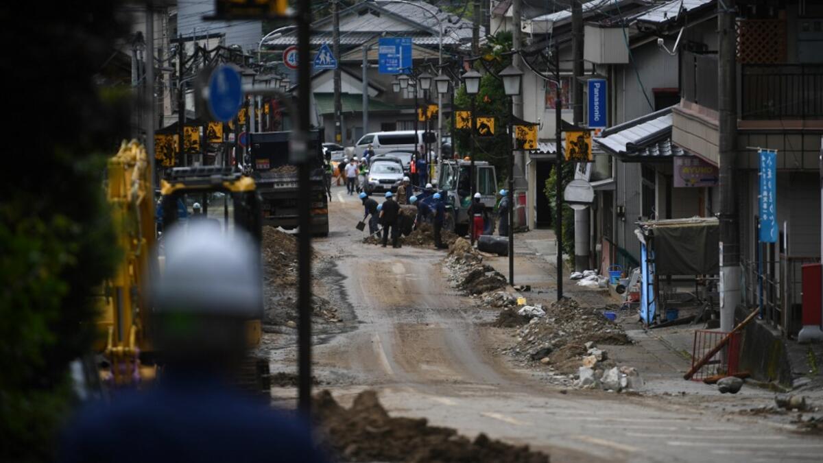 Debris litter a village following heavy rains and flooding in the village of Gero, Gifu prefecture on July 9, 2020. Japanese emergency services and troops were scrambling to reach thousands of homes cut off by devastating flooding and landslides that have killed dozens and caused widespread damage. Philip FONG / AFP