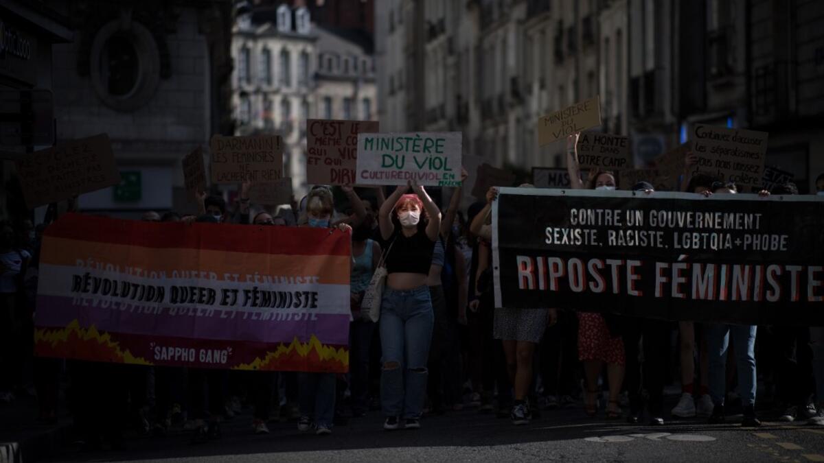 Protesters hold signs and banners as they take part in a demonstration called by feminist movements in Nantes, western France, on July 10, 2020, to denounce the nomination of French Interior Minister, facing rape accusations and French Justice Minister who criticised the #MeToo movement against sexual harassment. LOIC VENANCE / AFP