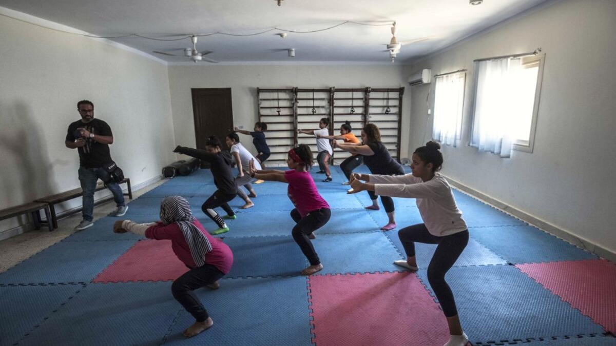 Youths from the "Children without Shelter" program attend a fitness sessions in their residences at Banati foundation in 6th October City on the outskirts of the capital Cairo on July 13, 2020.Khaled DESOUKI / AFP