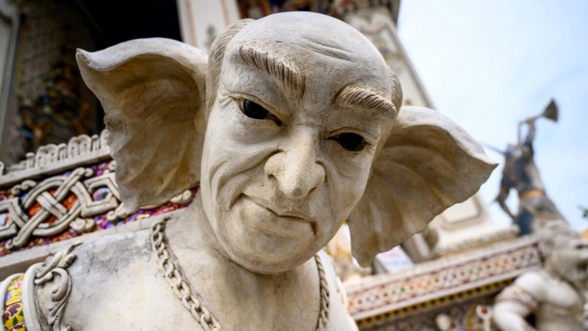 This photograph taken on July 14, 2020 shows the statue of an imaginary creature outside the Wat Pariwat Buddhist temple in Bangkok. Wat Pariwat, also known as "the David Beckham Temple", is decorated with statues of superheroes and comic characters as well as mythical and imaginary creatures. A golden-plated sculpture of the English football player holding the base of a Buddha statue in one of the buildings gives the temple its nickname.