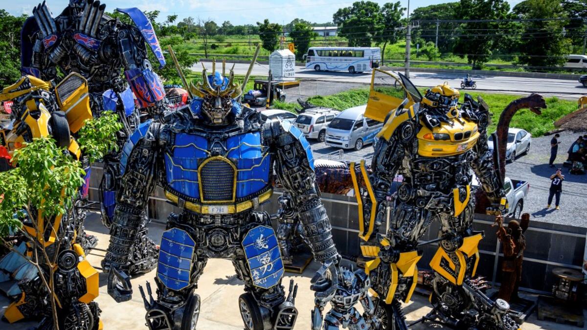 This photograph taken on July 18, 2020 shows life-sized sculptures of characters from the "Transformers" film franchise made of scrap metal parts at the Ban Hun Lek museum in Ang Thong, some 100km north of Bangkok. "Ban Hun Lek" or "The House of Steel Robots" is a museum where a collective of artists display their scrap metal creations depicting popular comics and sci-fi film characters. Mladen ANTONOV / AFP