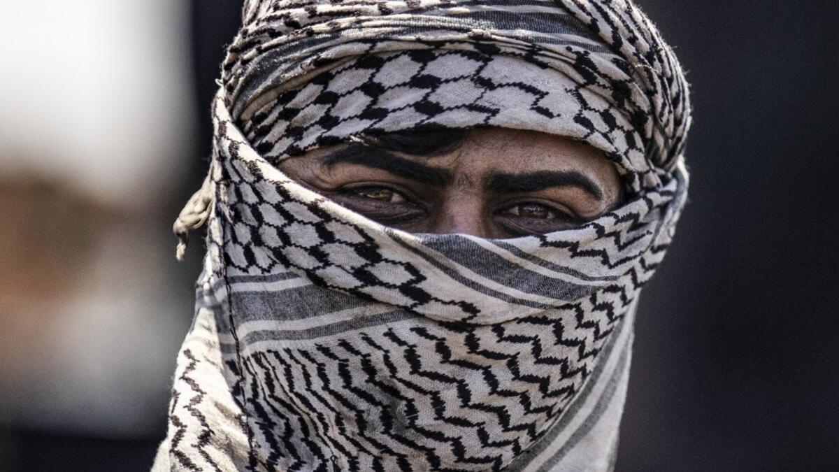 A man works at a makeshift refinery using burners to distill crude oil in the village of Bishiriya in the countryside near the town of Qahtaniya west of Rumaylan (Rmeilan) in Syria's Kurdish-controlled northeastern Hasakeh province, on July 19, 2020. DELIL SOULEIMAN / AFP
