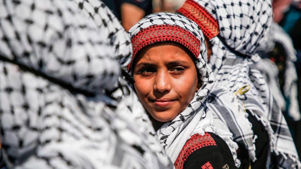 Palestinian children dressed in traditional dress attend a march marking Palestinian traditional customs day, in Gaza City. AFP