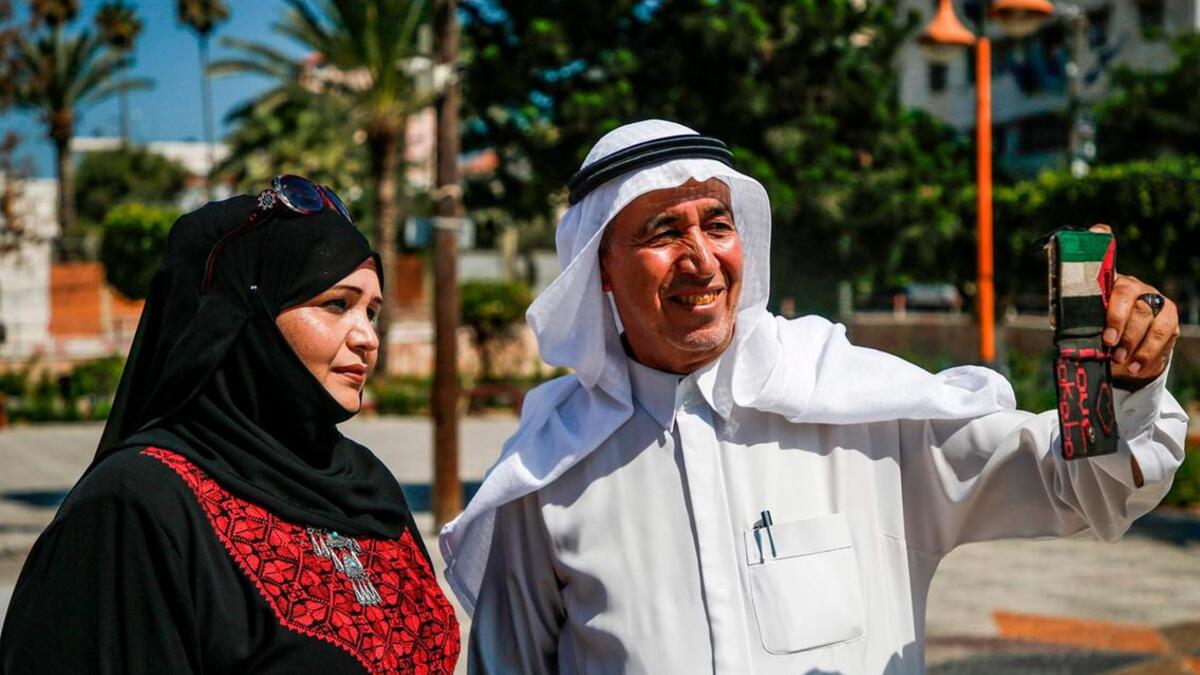 A Palestinian man takes a "selfie" on Palestinian traditional customs day, in Gaza City. AFP