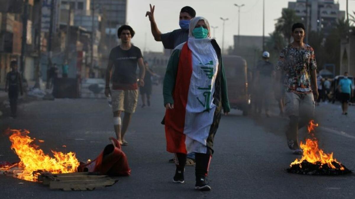 Iraqi demonstrators clash with security forces in a square in central Baghdad Iraqi demonstrators clash with security forces in a square in central Baghdad (AFP Photo/AHMAD AL-RUBAYE)