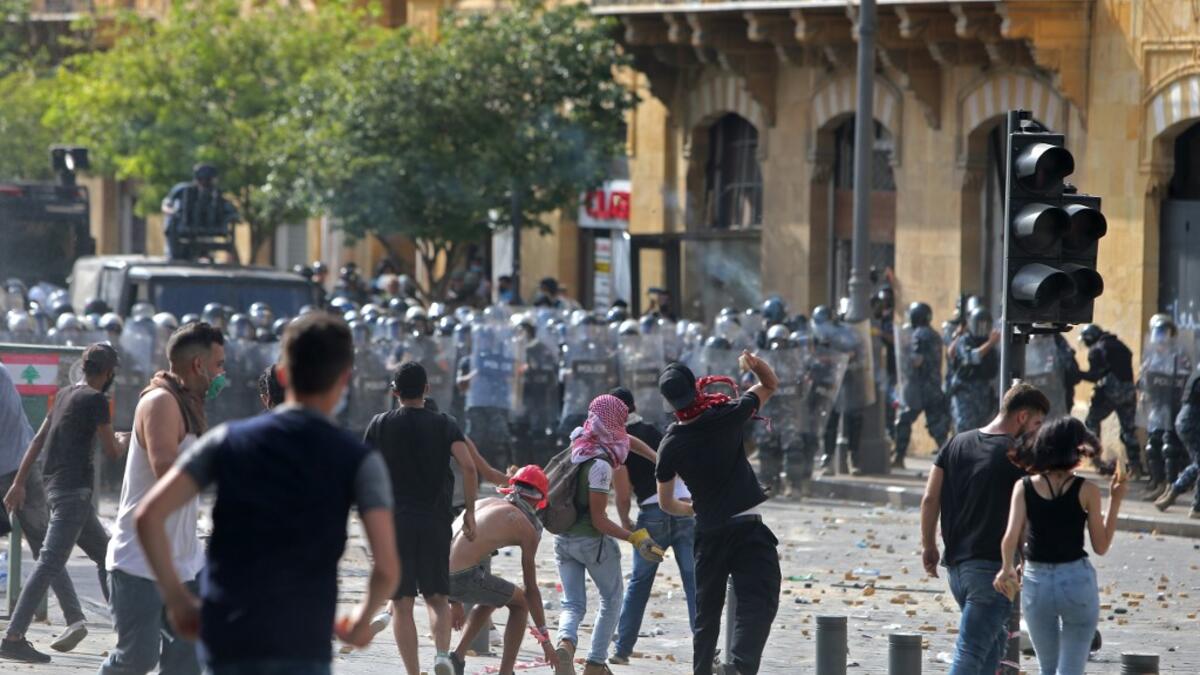 Lebanese protesters hurl rocks towards security forces during clashes in downtown Beirut on August 8, 2020, following a demonstration against a political leadership they blame for a monster explosion that killed more than 150 people and disfigured the capital Beirut. STR / AFP