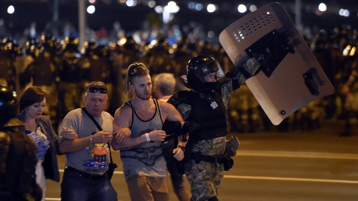 Riot police detain a group of demonstrators during a protest after polls closed in Belarus' presidential election, in Minsk on August 9, 2020. Sergei GAPON / AFP