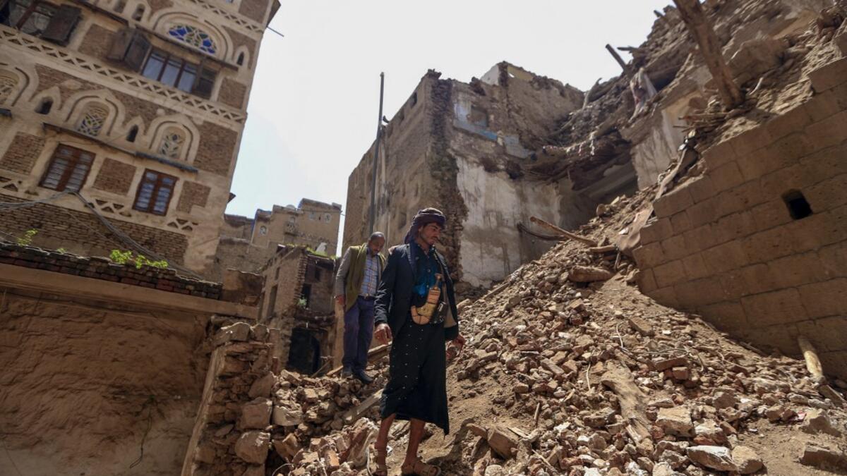 Yemeni men inspect the damage on the site of a collapsed UNESCO-listed building following heavy rains, in the old city of the Yemeni capital Sanaa, on August 12, 2020. Flash floods triggered by torrential rains have killed at least 172 people across Yemen over the past month, damaging homes and UNESCO-listed world heritage sites, officials said. Mohammed HUWAIS / AFP