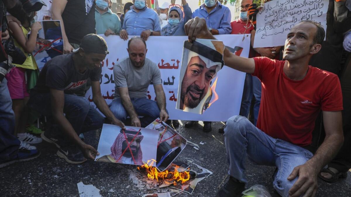 Palestinian protesters burn pictures of Abu Dhabi Crown Prince Sheikh Mohammed bin Zayed Al Nahyan (top) and Saudi Crown Prince Mohammed bin Salman, during a demonstration against the Emirati-Israeli agreement, in Ramallah in the occupied West Bank, on August 15, 2020. ABBAS MOMANI / AFP