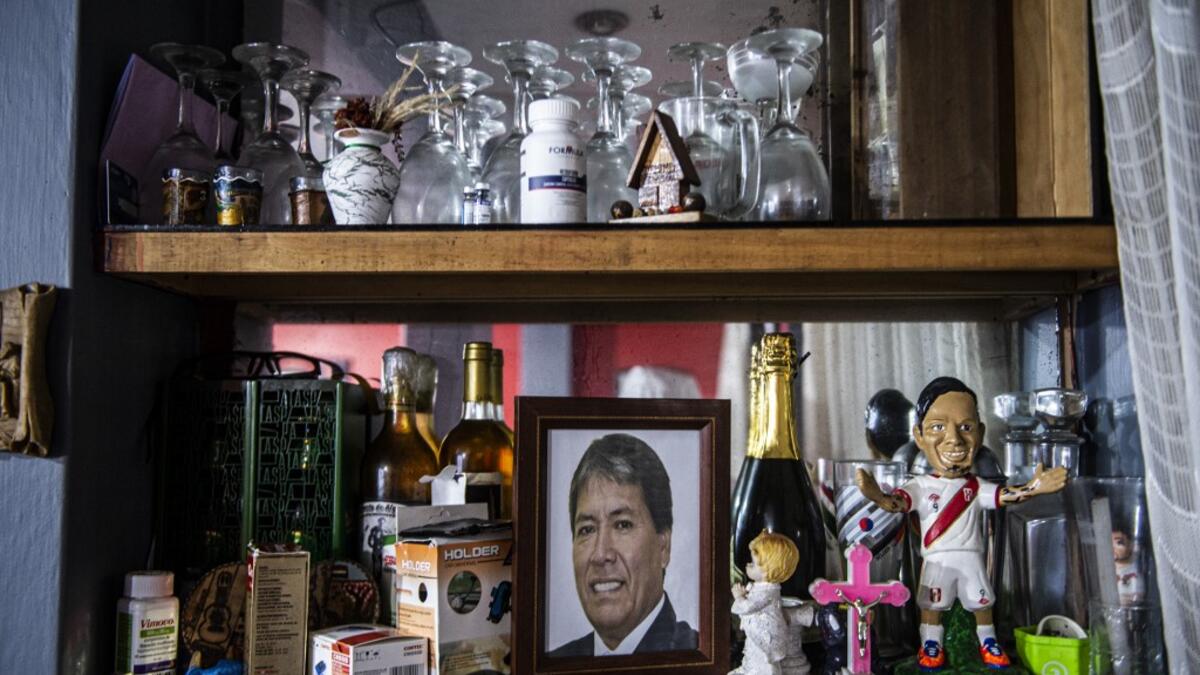View of a photo of Peruvian Ernesto Diaz, 55, who died from COVID-19 virus on a shelf of his home in Chorrillos, south of Lima, Peru on August 11, 2020. Global deaths from the coronavirus have almost reached on September 25, 2020 the grim threshold of one million. Around one-third of fatalities were in Latin America, where countries with overstretched medical resources are preparing for a further onslaught. ERNESTO BENAVIDES / AFP