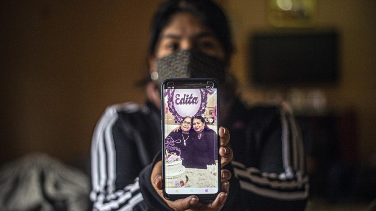 Peruvian Julizza Navarro, 32, shows a picture of her mother Maribel Diaz (R), 52, and her grandmother Edita Leiva (L), 76, who died from COVID-19, at her home in Chorrillos, south of Lima, Peru on August 11, 2020. Global deaths from the coronavirus have almost reached on September 25, 2020 the grim threshold of one million. Around one-third of fatalities were in Latin America, where countries with overstretched medical resources are preparing for a further onslaught. ERNESTO BENAVIDES / AFP