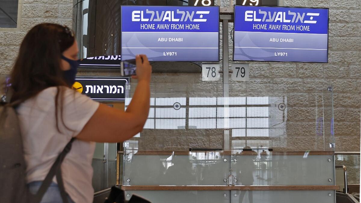 A picture taken on August 31, 2020, shows a passenger taking a picture of screens displaying the flight number of the first-ever commercial flight from Israel to the UAE at the Ben Gurion Airport near Tel Aviv, which will carry a US-Israeli delegation to the UAE following a normalisation accord. JACK GUEZ / AFP