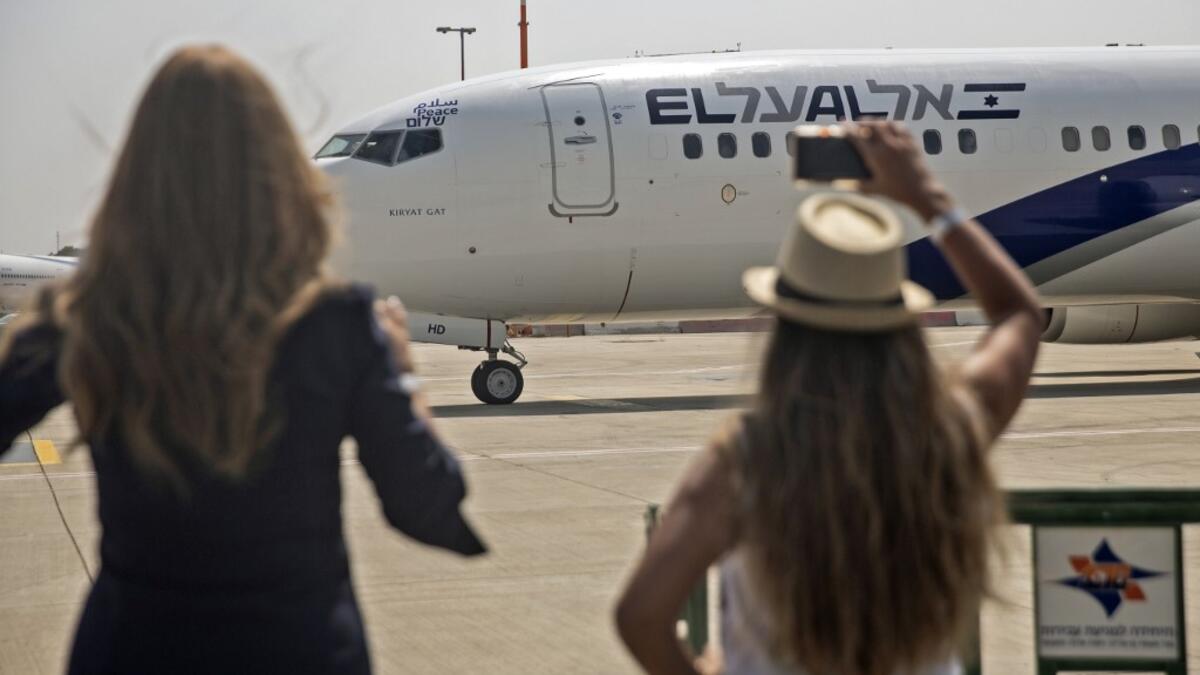 A picture taken on August 31, 2020, shows Israeli women taking pictures of the El Al's airliner, ahead of the first-ever commercial flight from Israel to the UAE at the Ben Gurion Airport near Tel Aviv, which will carry a US-Israeli delegation to the UAE following a normalisation accord. Heidi levine / POOL / AFP