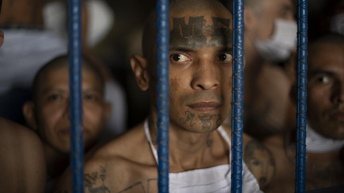 Members of the MS-13 and 18 gangs remain inside their cells during a visit by the Director of the General Directorate of Penal Centers, Osiris Luna (out of frame), at the maximum security prison in Izalco, Sonsonate, El Salvador, on September 4, 2020. Authorities from the General Directorate of Penal Centres (DGCP) visited three Salvadorean prisons, some of maximum security, to check the situation of inmates and carry out searches amid the COVID-19 novel coronavirus pandemic. Yuri CORTEZ / AFP