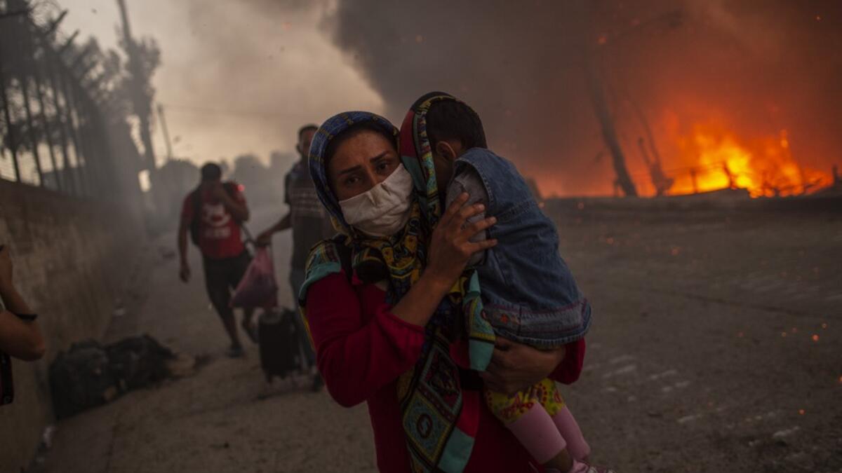 A large fire broke out at Moria, Europe's largest refugee camp on Lesbos in Greece, forcing thousands including many families with children out into the streets with nowhere to sleep.   A second fire aggravated the crisis on the island of Lesbos, where authorities have declared a state of emergency.  The first blaze, which began hours after 35 people tested positive for coronavirus at the Moria camp, sent thousands fleeing for safety into surrounding olive groves.