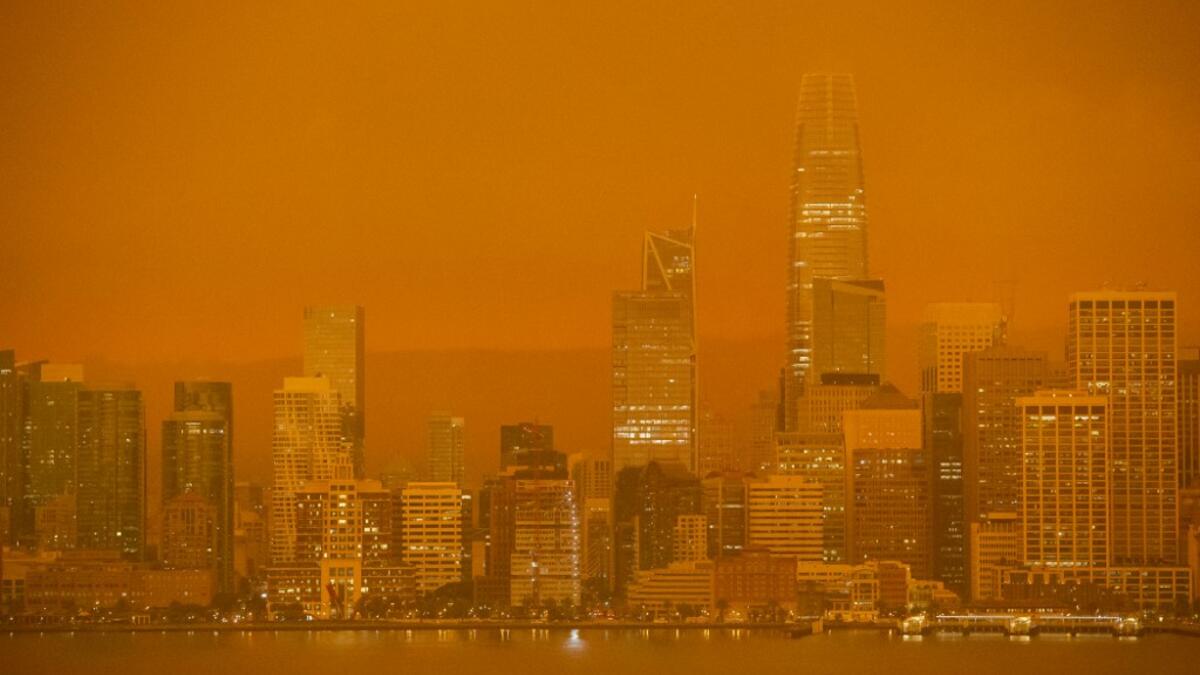 The San Francisco skyline is obscured in orange smoke and haze as their seen from Treasure Island in San Francisco, California on September 9, 2020. More than 300,000 acres are burning across the northwestern state including 35 major wildfires, with at least five towns "substantially destroyed" and mass evacuations taking place. Brittany Hosea-Small / AFP
